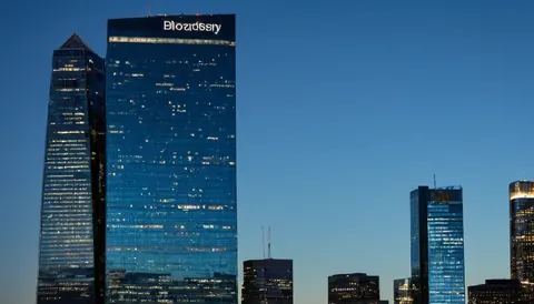 Modern glass skyscrapers illuminated at dusk with blue sky background