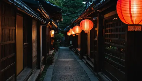 Red paper lanterns illuminate a quiet stone alleyway between wooden buildings at night.
